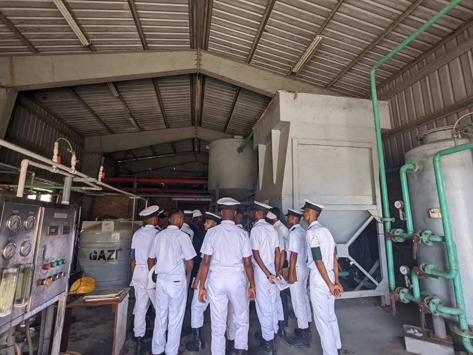Cadets being briefed around pumps and pressure vessels in a plant room